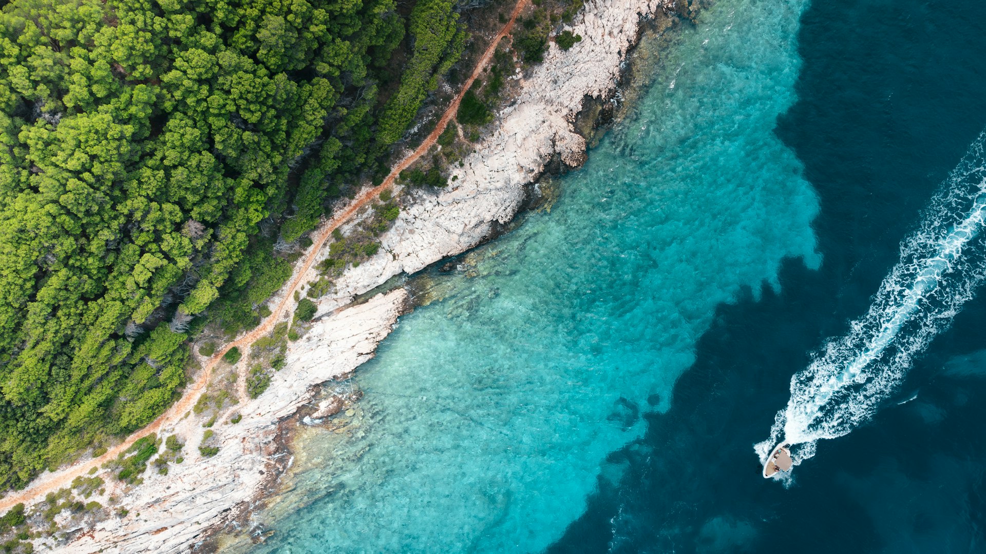 an aerial view of a boat in the water